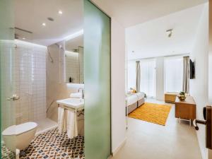 a bathroom with a toilet and a sink at ibis Styles Golden Sands Roomer Hotel in Golden Sands