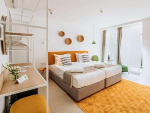 a bedroom with a large bed and a ladder at ibis Styles Golden Sands Roomer Hotel in Golden Sands