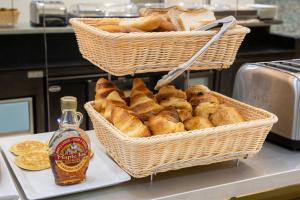 
a wooden table topped with baskets filled with bread at Hotel Saint Georges in Nice
