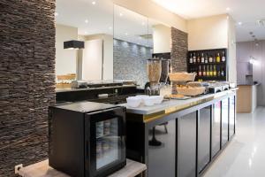 a kitchen with a counter with food and drinks at Hotel Saint Georges in Nice