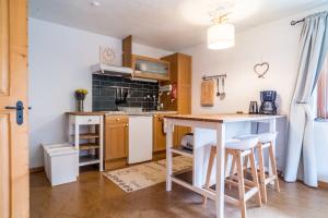 a kitchen with a table and chairs in a room at Apartment Rybibach Retreat - GRIWA RENT AG in Lauterbrunnen +5 photos