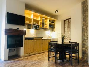 a kitchen with a table and chairs and a television at Breakaway Dream Holiday House in San Felice del Benaco