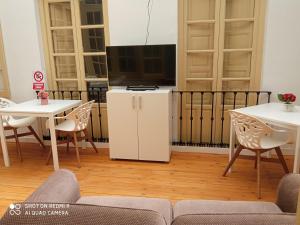 a living room with a tv and a table and chairs at OLD TOWN in Ronda