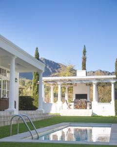 a house with a swimming pool in the yard at Lily Pond House at Le Lude in Franschhoek