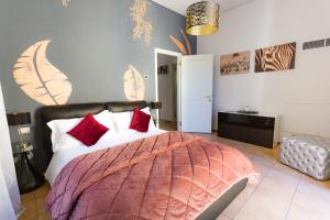 a bedroom with a large bed with red pillows at Relais Di Giada in Como