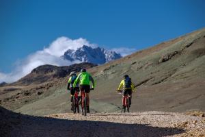 three people riding bikes on a mountain trail at Explora en Parque Nacional Patagonia in Cochrane