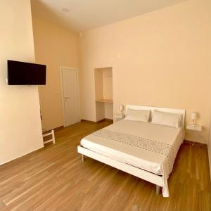 - une chambre avec un lit et une télévision à écran plat dans l'établissement Clelia's Room, à Naples