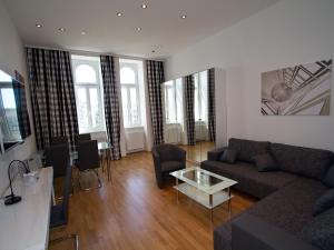 a living room with a couch and a table at Apartment Nähe Zentrum in Vienna