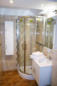 a bathroom with a shower and a sink at Jopi Hostel Katowice Centrum in Katowice