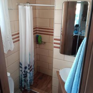 a bathroom with a shower curtain and a sink at Casa D'armaros in Kissamos