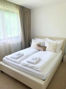 A bed or beds in a room at White Luxury Villa Esztergom