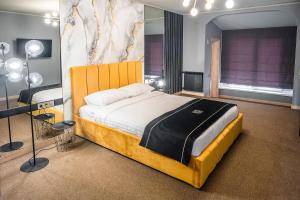 a bedroom with a large bed and a desk at RICH Boutique-Hotel in Vinnytsya