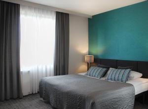 Posteľ alebo postele v izbe v ubytovaní Hotel Perła