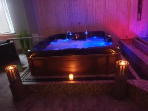 a bath tub with a candle in a room at Berghotel Drei Brüder Höhe in Marienberg