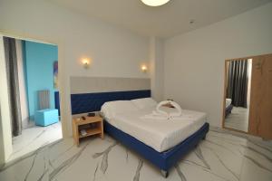 a bedroom with a bed and a large window at Hotel San Crispino in Morrovalle