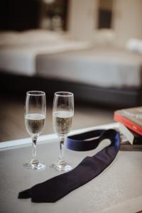 two glasses of wine on a table with a ribbon at Wanderlust Relais Vaticano in Rome