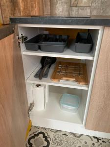 a kitchen drawer with some dishes and utensils at JuNgLe ROOM in Romans-sur-Isère