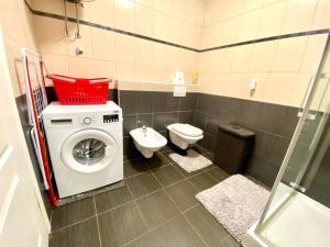 a bathroom with a washing machine and a toilet at Sunny apartment by the beach in Kastel Stafilic +31 photos