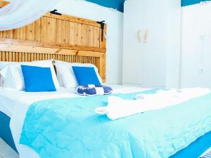 a blue and white bed with towels on it at Klima Paradise in Klíma +16 photos