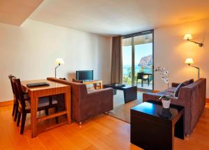 a living room with a couch and a table at Golden Residence Hotel in Funchal