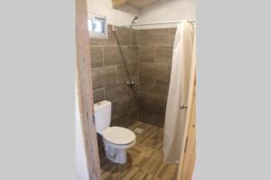a bathroom with a toilet and a shower at Santo Descanso in Punta Del Diablo +65 photos