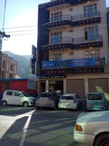 a group of cars parked in front of a building at Hotel Tour De Swat in Swat