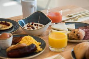 a table topped with plates of breakfast foods and drinks at Golden Tulip Porto-Vecchio in Porto-Vecchio