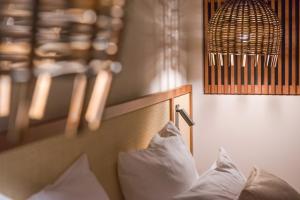 A bed or beds in a room at Golden Tulip Porto-Vecchio