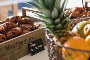 a display of different types of pastries and a pineapple at Golden Tulip Porto-Vecchio in Porto-Vecchio