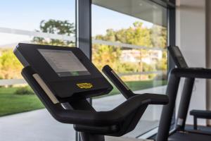 a tablet sitting on a treadmill in a gym at Golden Tulip Porto-Vecchio in Porto-Vecchio