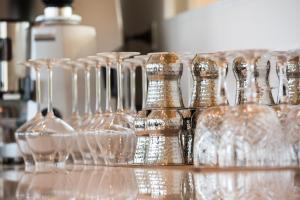 a group of wine glasses sitting on a counter at Golden Tulip Porto-Vecchio in Porto-Vecchio