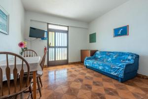 a living room with a blue couch and a table at Apartments Laura in Dramalj