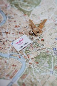 a map with a pair of scissors on top of it at Wanderlust Relais Vaticano in Rome
