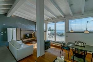 a living room with a couch and a table at Sicilia's Art Hotel & Spa in Acitrezza