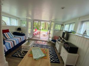 a living room with a couch and a tv at Clear Pond Suite in Plymouth