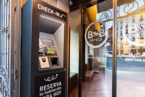 a ticket machine in front of a store at B&B HOTEL Madrid Centro Plaza Mayor in Madrid