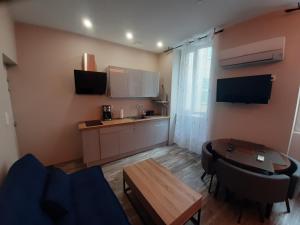 a living room with a kitchen and a table at 3 Apt T2 COSY de 40 à 50 M2 Idéal pour un déplacement PRO " Les IRIS " in Bourg-Saint-Andéol