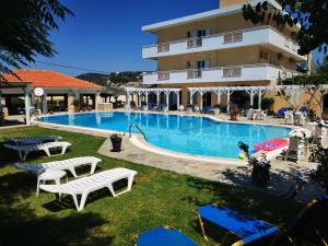 a swimming pool in front of a hotel at Nafsika Hotel in Agios Stefanos