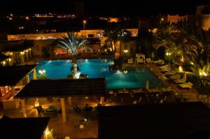a view of a swimming pool at night at Berbère Palace in Ouarzazate