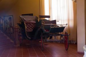 a carriage sitting in a room with a staircase at Berbère Palace in Ouarzazate