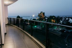 a balcony with a view of the ocean at night at Ceneviz Suit Hotel in Akçakoca
