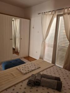a bedroom with a bed with two pairs of shoes on it at Apartman Martić in Klek