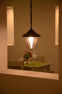 a light hanging over a table in a dining room at Hippocampus Hotel in Kamari