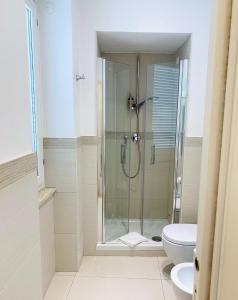 a bathroom with a shower, toilet and sink at Via Del Corso Home Roma in Rome