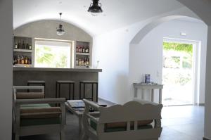 a tasting room with a bar with wine bottles at Hippocampus Hotel in Kamari