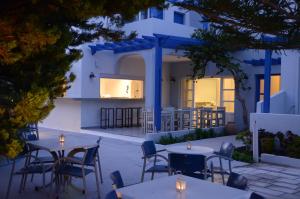 a restaurant with tables and chairs in front of a building at Hippocampus Hotel in Kamari