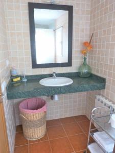 a bathroom with a sink and a mirror at Hort de la Cinteta in Alcover