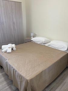 a bedroom with a bed with two towels on it at casa vacanza Antico Baglio in Castelbuono