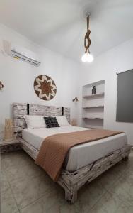 a bedroom with a large bed with a wooden frame at Alexandra's Boutique House in Triovasálos