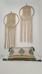 two beaded curtains hanging on a wall with a pillow at Alexandra's Boutique House in Triovasálos